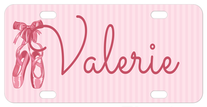 Pretty ballet slippers tied with a bow on the straps on a soft pink striped background personalized license plate with any name