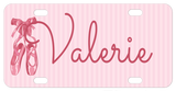 Pretty ballet slippers tied with a bow on the straps on a soft pink striped background personalized license plate with any name