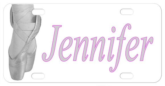 Greyscale depiction of ballet dancers feet in toe shoes on pointe, with any name personalized on a custom license plate for ballerinas. 