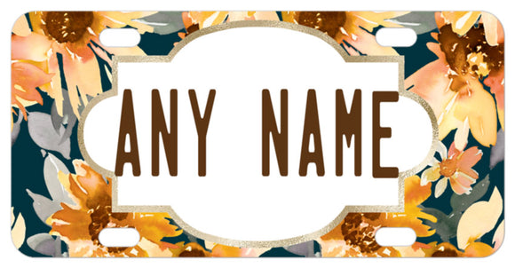 Tones of yellow and orange flowers on a deep green and gray background license plate with your name