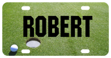 Personalized vanity license plate with golf ball next to hole on green custom printed with any name