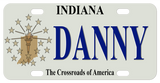 Indiana mini license plate with tan version of the fag with flame, stars, and shape of the state on the left with any name to the right in the center of the plate.