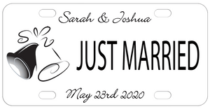 2 Wedding Bells 1 black 1 white on left with text on top, center and bottom. Plate is white with black text