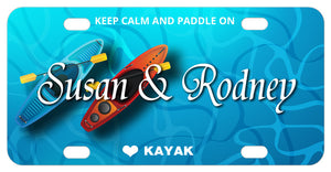 2 kayaks in water illustration on a custom license plate personalized with 2 names in the center and text on top and bottom