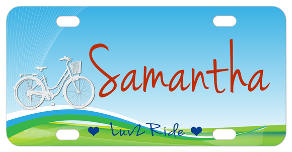 bike with basket on a hill claiming you luv 2 ride but you can personalized this custom bike plate with any text.