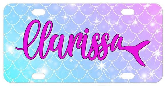 Gradient blue to purple mermaid scales with sparkles along with any name in fancy script with the last letter ending in a trailing mermaid tail.