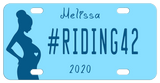 Blue Background with silhouette of a pregnant woman with a blue heart in her belly. Our sample reads #RIDING42 in the center with name on top and year on bottom. You can personalize with any text in all three areas