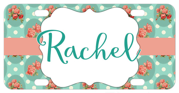 Rose bouquets scattered on a soft green polka dotted background with a coral ribbon Your name in a decorative frame