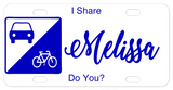 Sign on left with car and bike in triangle sections license plate design with your custom text to let everyone know you share the road