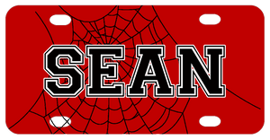 Red background with black spiderweb and any name personalized over part of  the web centered in plate